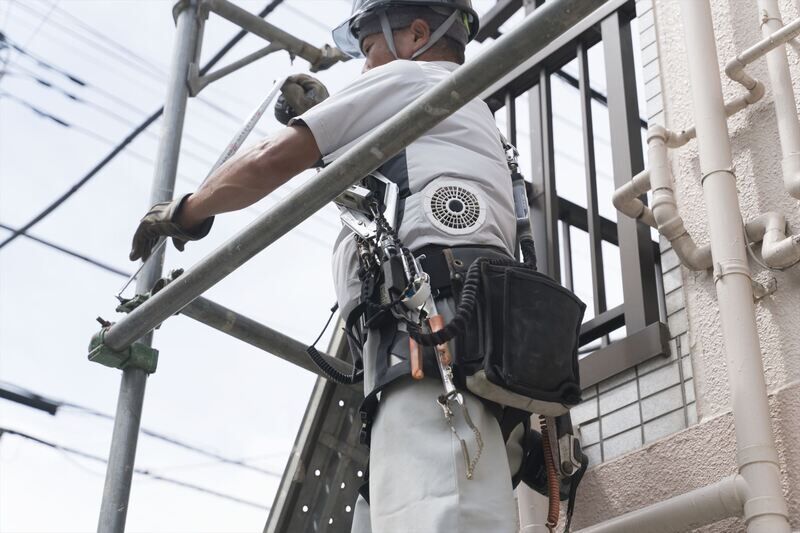 足場の手すりを解体するスタッフ